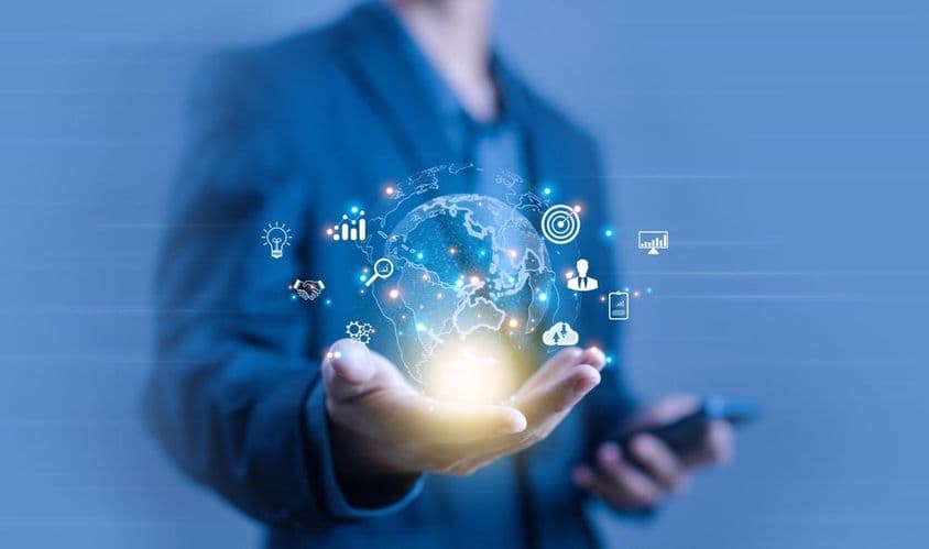 Uma pessoa segurando uma projeção digital em forma de globo.