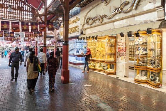 Mercado de ouro de Dubai, uma loja exibindo joias de ouro, com pessoas passando.