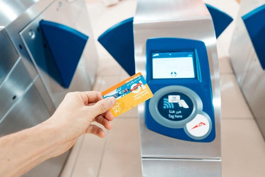 Uma pessoa segurando um cartão Nol de edição limitada de 10º aniversário em uso no metrô.