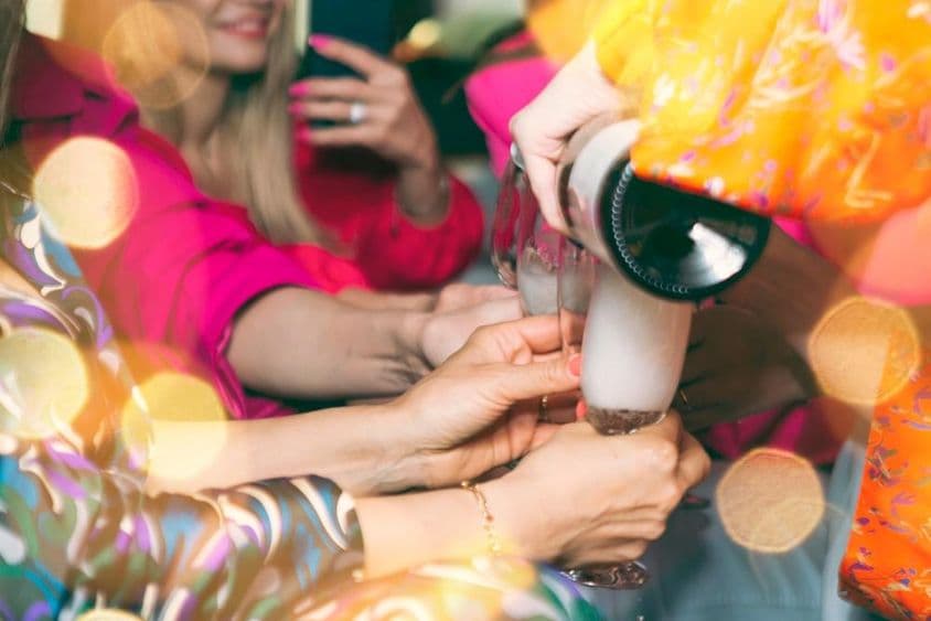 Pessoas bebendo champanhe em uma boate.