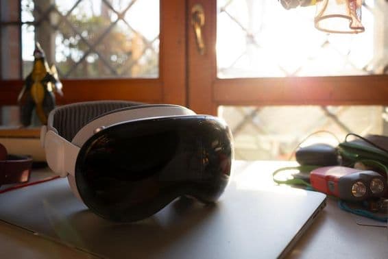 Apple Vision Pro sobre um caderno em uma mesa.