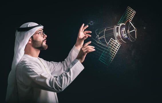 Homem muçulmano em frente a satélite projetado.