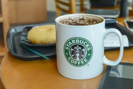 Cappuccino de cacau em uma caneca quente e fumegante em uma cafeteria Starbucks.