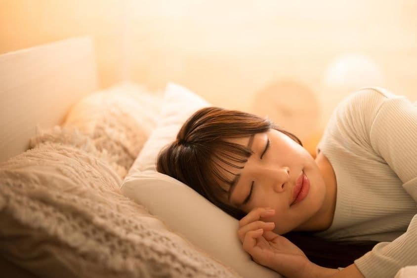 Uma mulher dormindo na cama.