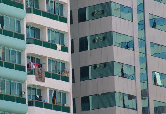 Um arranha-céu moderno em Abu Dhabi com algumas varandas com tapetes.