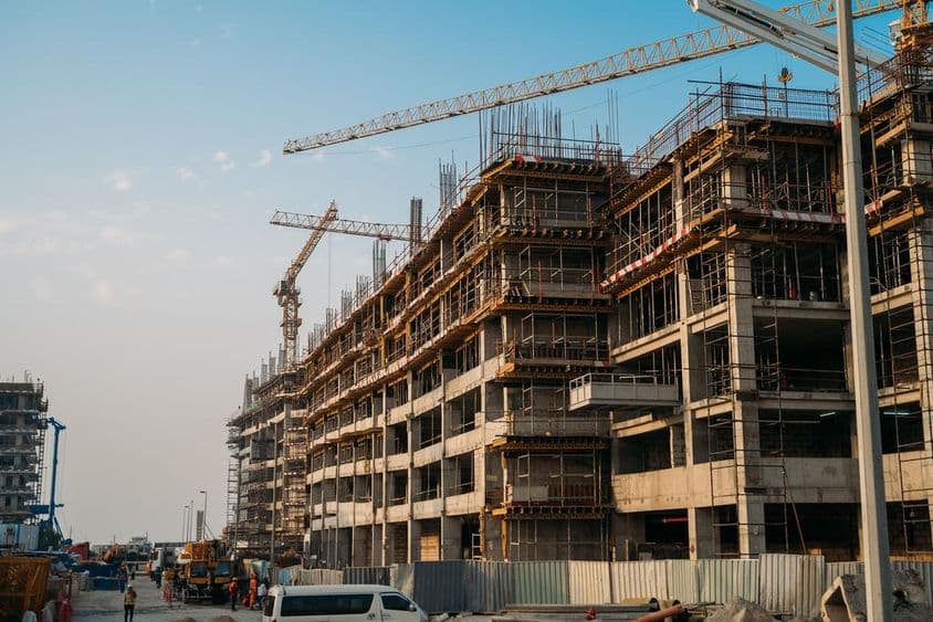 Construção moderna com guindastes industriais em Dubai.