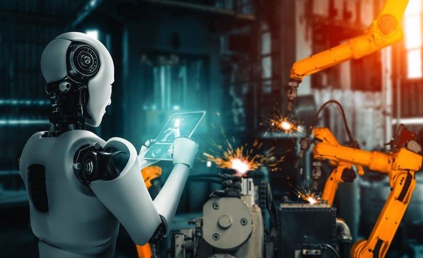 Inteligência artificial supervisionando braços robóticos durante um processo de montagem na linha de produção.