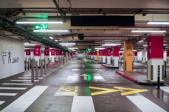 Imagem de uma garagem de estacionamento moderna e espaçosa em Dubai com iluminação vívida.