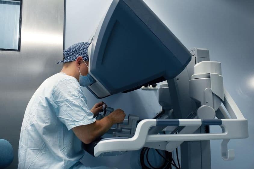 Um robô médico é operado remotamente por um médico através de um monitor.