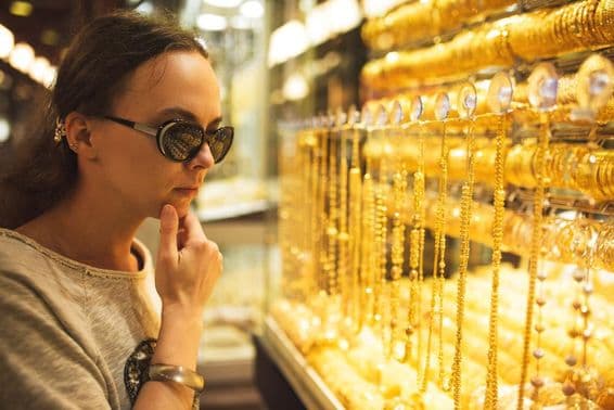 Uma jovem escolhendo joias no mercado de ouro de Dubai.