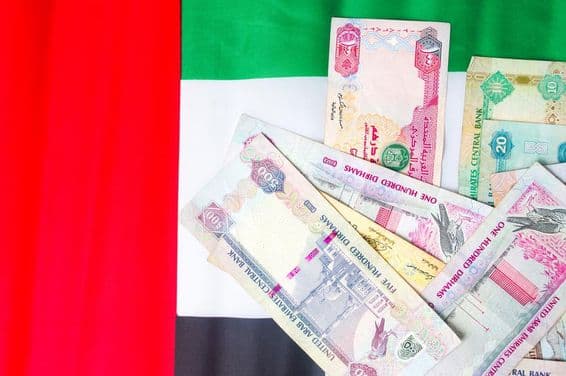 Cédulas de dirham dos EAU sobre a bandeira nacional.