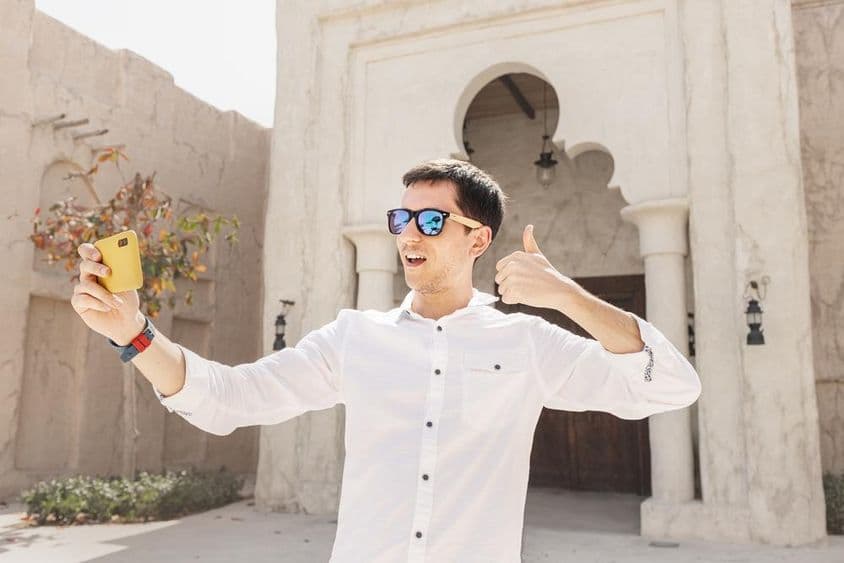 Homem gravando um vídeo blog no antigo distrito de Bur Dubai Creek.