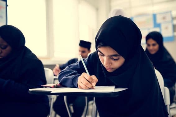 Crianças muçulmanas aprendendo em uma sala de aula.