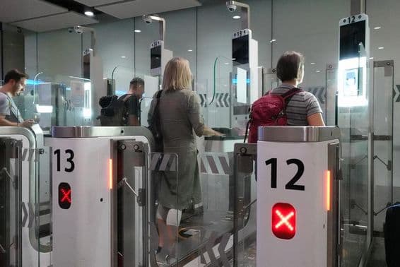 Passageiros de avião passando por controles automatizados de passaportes.