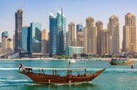 Antiga embarcação de madeira navegando na Marina de Dubai.