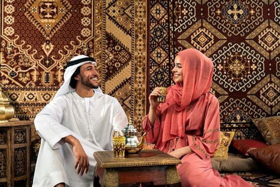 Jovem casal Emirati passando tempo em um café árabe tradicional.